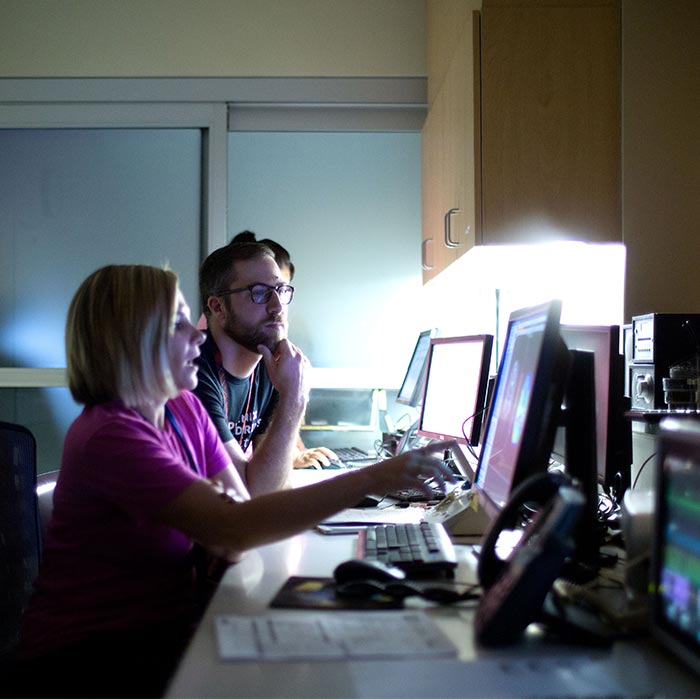 Physicians pointing at screens