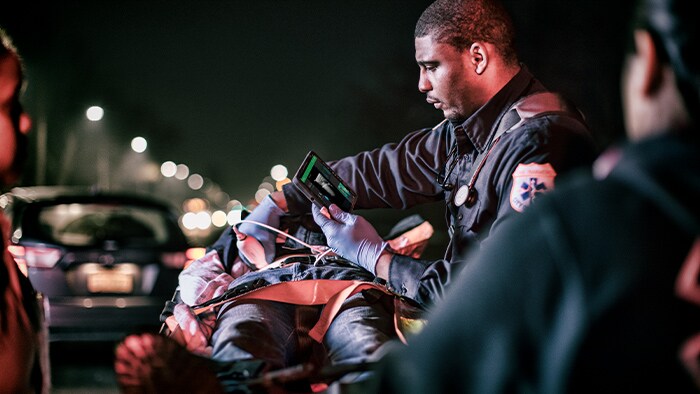 Clinician examining a patient as part of first aid