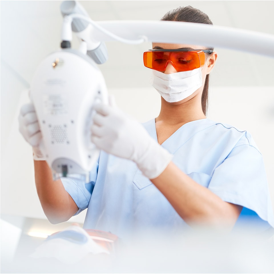 Dental professional adjusting a Zoom! WhiteSpeed lamp